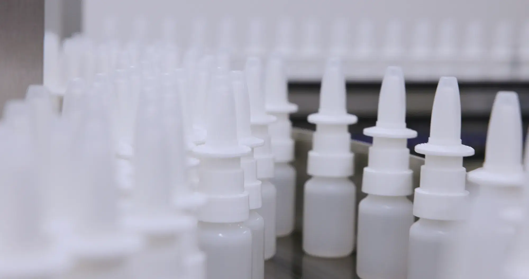 A line of nasal spray bottles